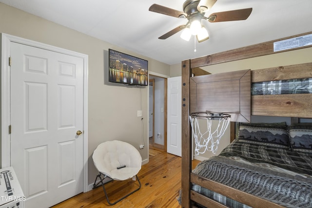 bedroom with ceiling fan and hardwood / wood-style floors