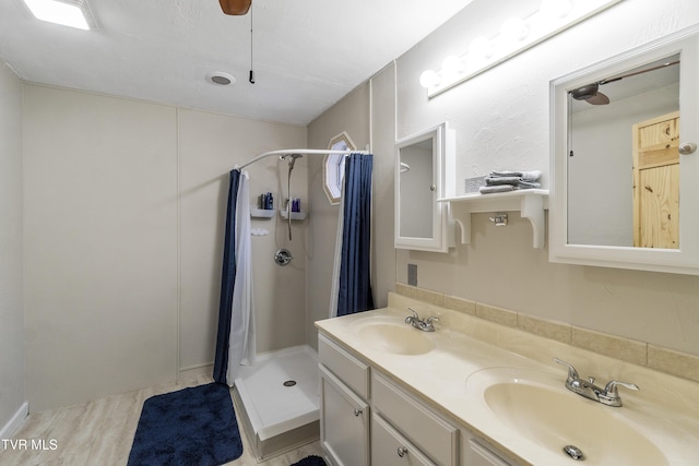 bathroom featuring walk in shower, vanity, and hardwood / wood-style floors