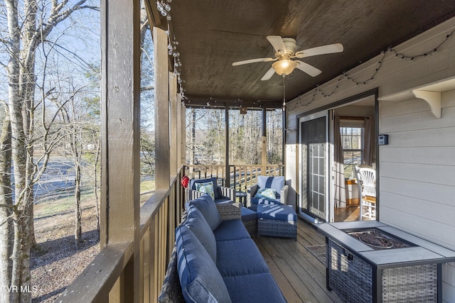 unfurnished sunroom featuring wooden ceiling and ceiling fan