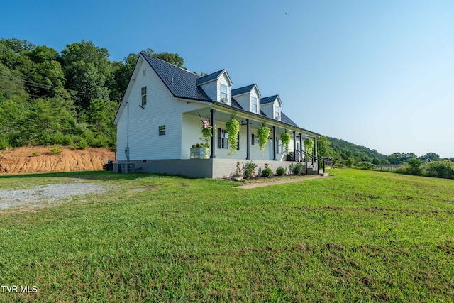 view of side of property featuring a porch and a lawn