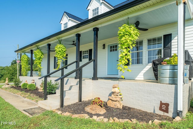 entrance to property featuring covered porch and ceiling fan