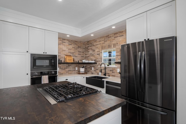 kitchen featuring fridge, oven, and white cabinetry