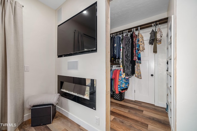 interior space with a textured ceiling and hardwood / wood-style floors