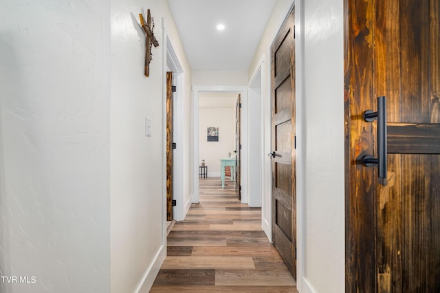 corridor with light wood-type flooring