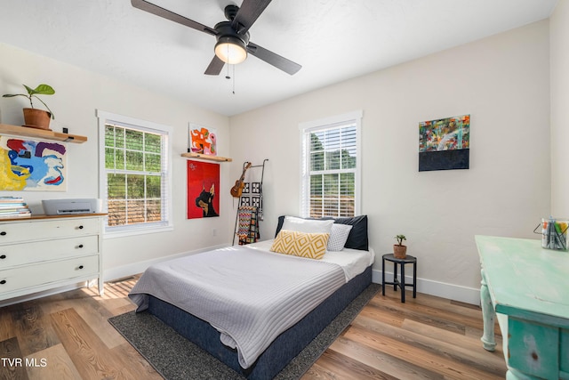 bedroom with ceiling fan and light hardwood / wood-style floors