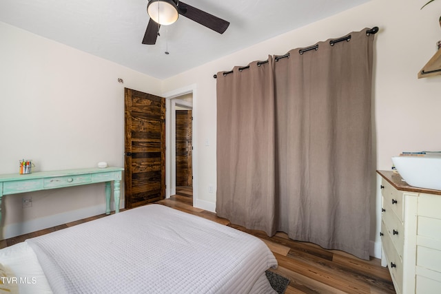 bedroom featuring hardwood / wood-style flooring and ceiling fan