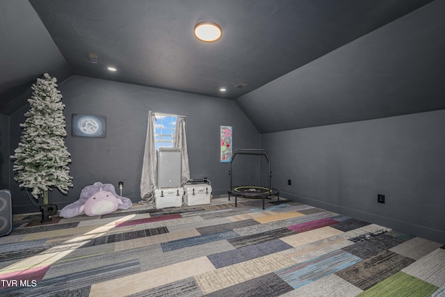 unfurnished bedroom featuring carpet flooring and vaulted ceiling