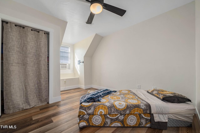 bedroom with ceiling fan, hardwood / wood-style floors, and cooling unit