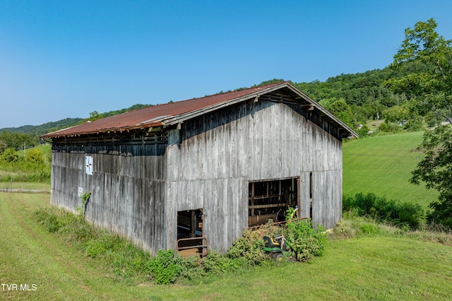 view of outbuilding featuring a yard