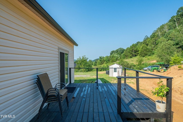 wooden deck featuring a shed