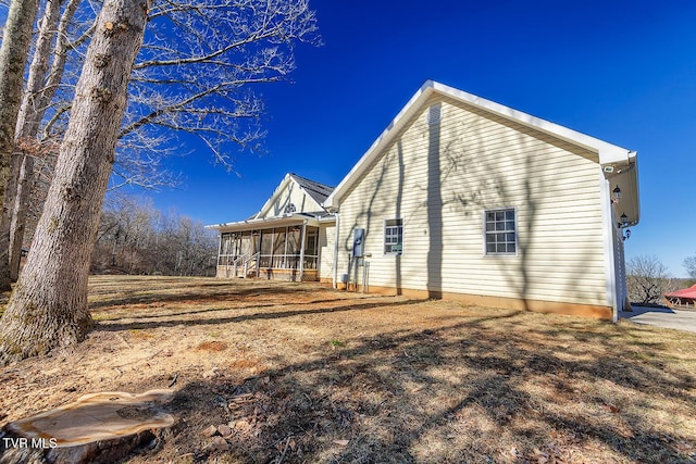 back of property with a sunroom