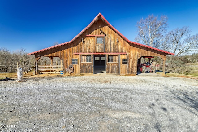 exterior space featuring an outbuilding, driveway, a detached garage, and an exterior structure