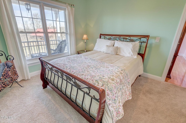 carpeted bedroom featuring baseboards