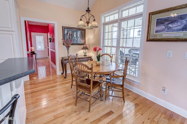 dining space featuring a chandelier and light hardwood / wood-style floors