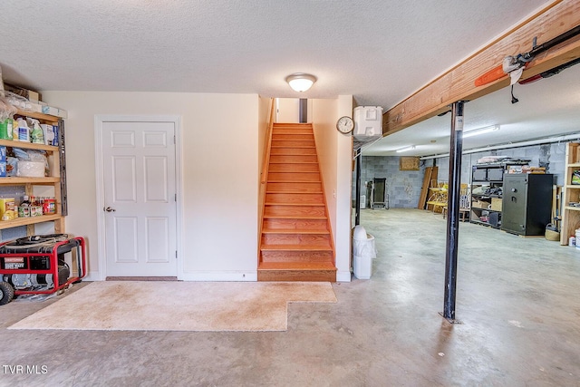 interior space featuring a textured ceiling and stairs