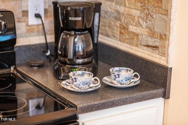 interior details featuring dark countertops and white cabinetry