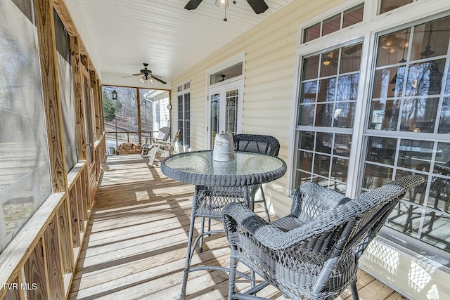 wooden deck featuring a ceiling fan