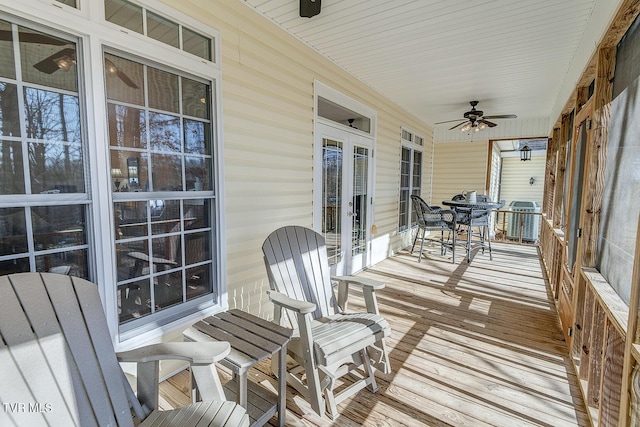 wooden deck featuring french doors and ceiling fan