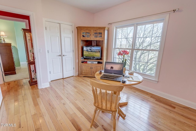 home office featuring baseboards and light wood-style flooring