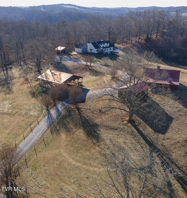 birds eye view of property featuring a view of trees and a rural view