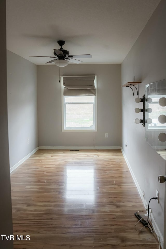 spare room with light hardwood / wood-style flooring and ceiling fan