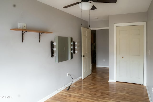 unfurnished bedroom with ceiling fan, light hardwood / wood-style floors, and a closet