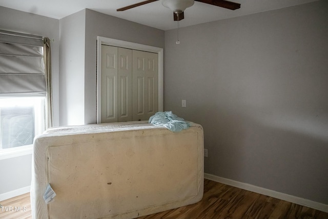 bedroom featuring ceiling fan, wood-type flooring, and a closet