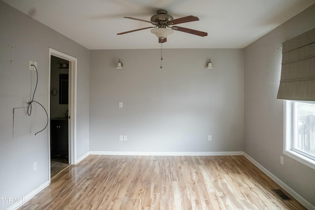 empty room featuring ceiling fan and light wood-type flooring