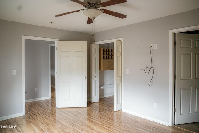 unfurnished bedroom with connected bathroom, light hardwood / wood-style floors, and ceiling fan