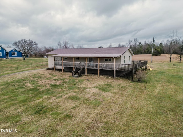 view of front facade featuring a front lawn and a deck