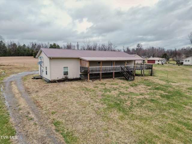 view of front of property with a wooden deck and a front lawn