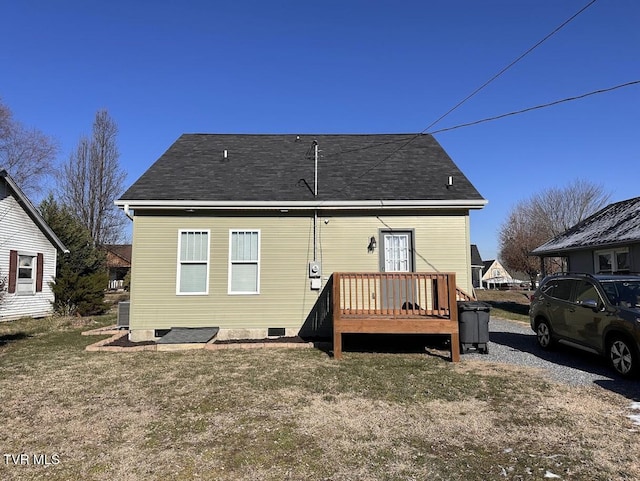 back of property featuring a lawn, a deck, and central air condition unit