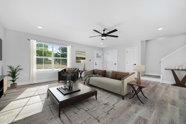 living room featuring ceiling fan and light wood-type flooring