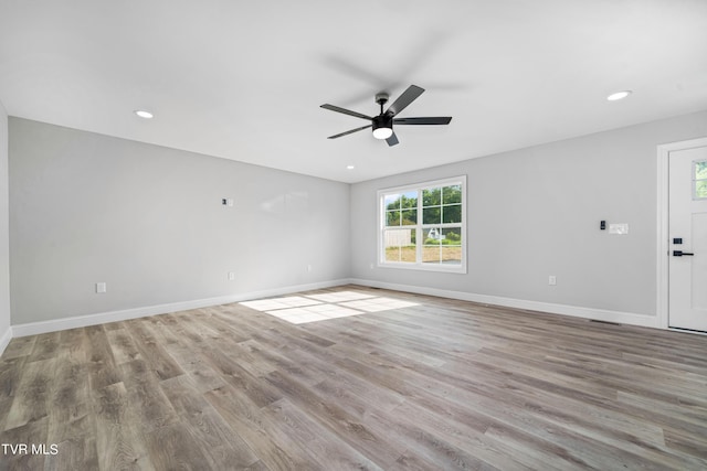 unfurnished room with light wood-type flooring and ceiling fan