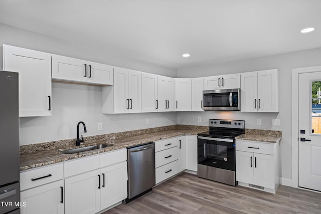 kitchen featuring white cabinetry, sink, and appliances with stainless steel finishes