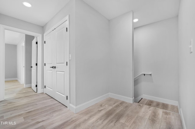 corridor with light hardwood / wood-style floors