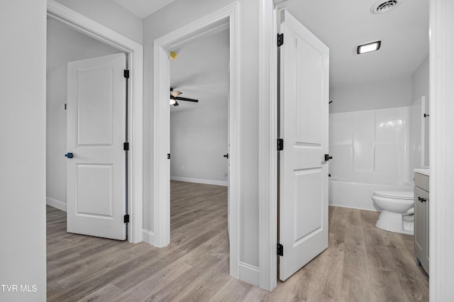 hallway with light hardwood / wood-style floors