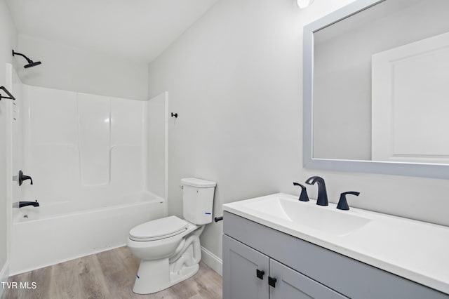 full bathroom featuring hardwood / wood-style floors, vanity,  shower combination, and toilet