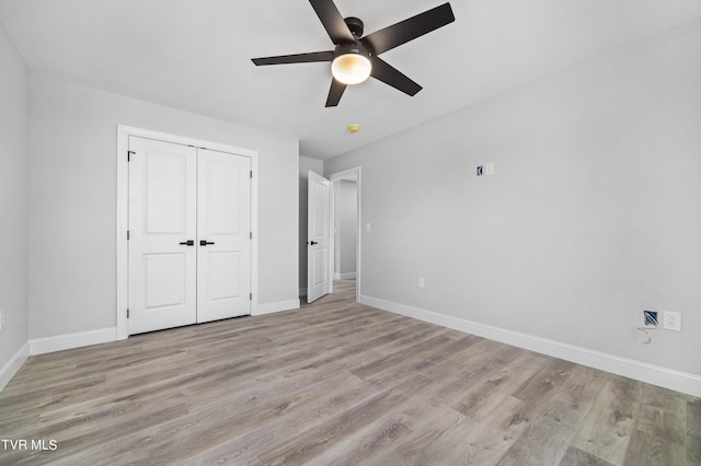 unfurnished bedroom featuring ceiling fan, a closet, and light hardwood / wood-style floors