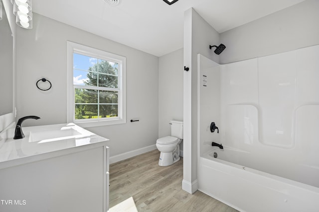 full bathroom with vanity, toilet, wood-type flooring, and bathtub / shower combination