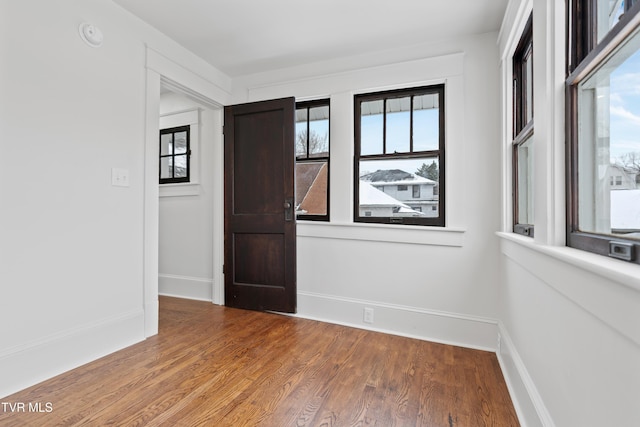 empty room featuring hardwood / wood-style floors and a wealth of natural light