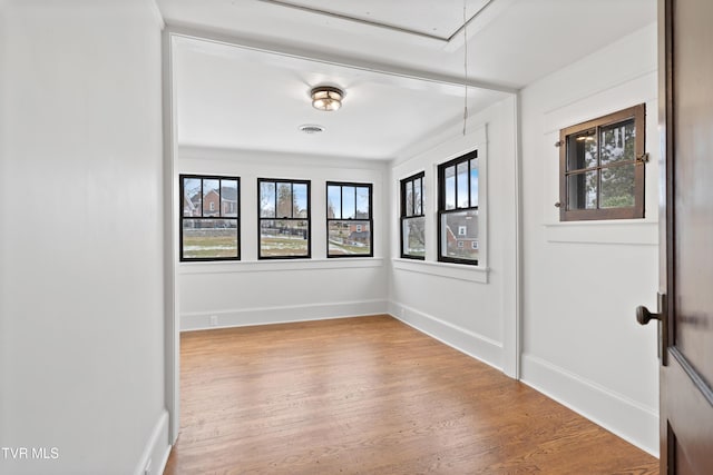 spare room with hardwood / wood-style floors