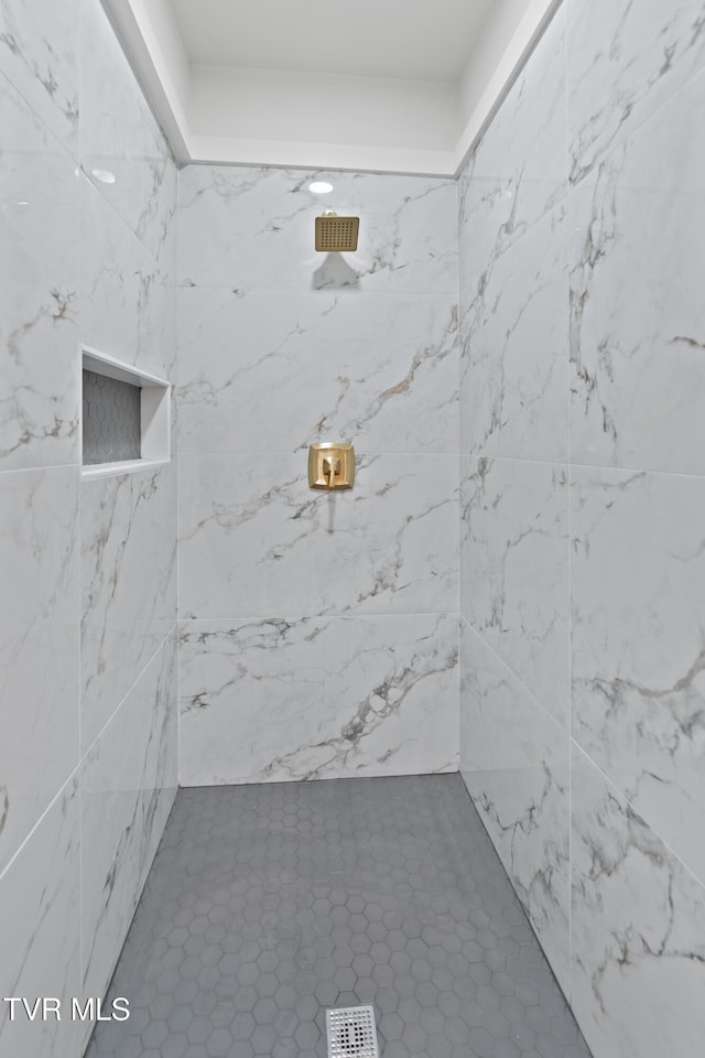 bathroom featuring tile patterned floors and tiled shower