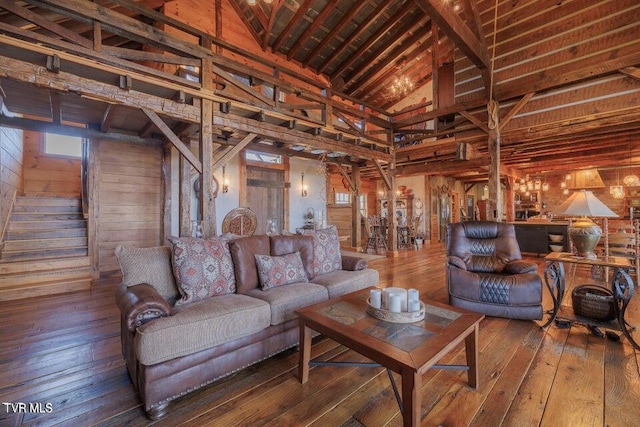 living room with wooden walls, hardwood / wood-style floors, high vaulted ceiling, wood ceiling, and beam ceiling