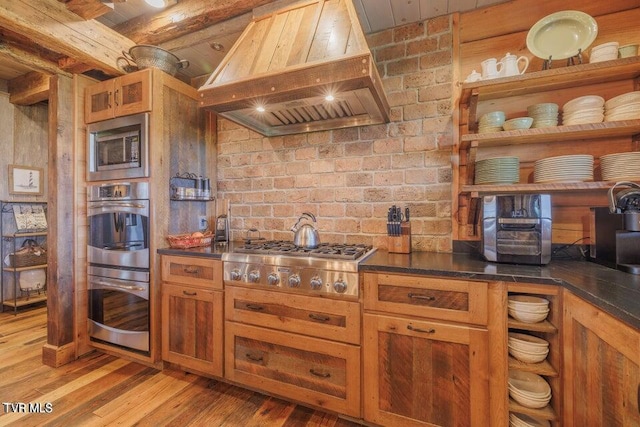 kitchen featuring stainless steel appliances, wooden ceiling, beamed ceiling, custom range hood, and light hardwood / wood-style flooring