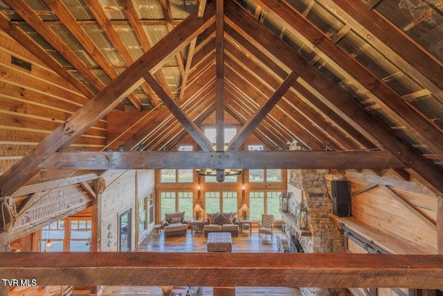 corridor featuring beam ceiling, wooden ceiling, and high vaulted ceiling