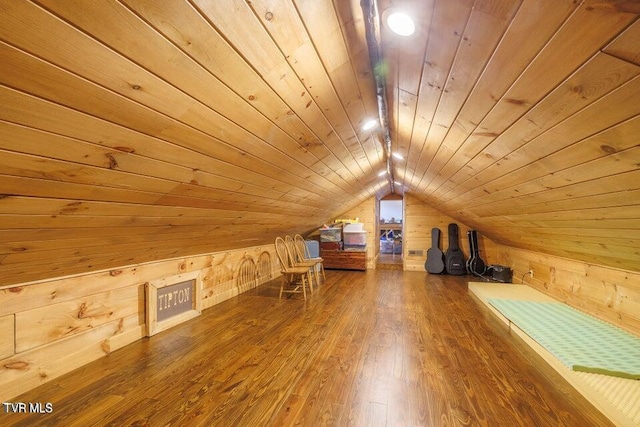 bonus room featuring hardwood / wood-style floors, wooden walls, wooden ceiling, and lofted ceiling