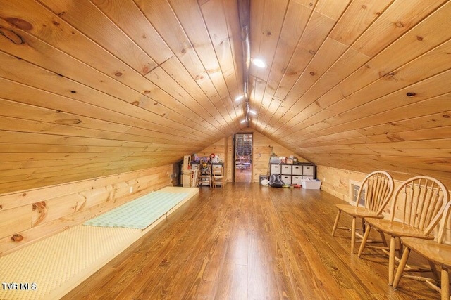 bonus room with wood ceiling, hardwood / wood-style floors, wood walls, and lofted ceiling