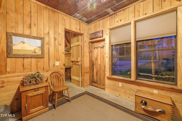 living area featuring wood walls and wooden ceiling