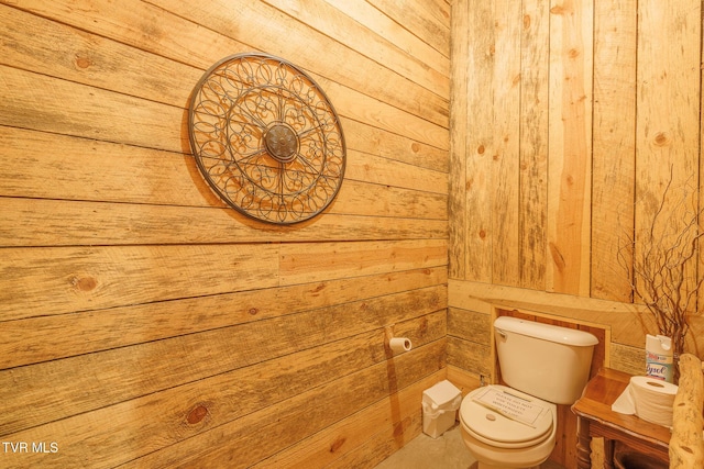 bathroom with wooden walls and toilet